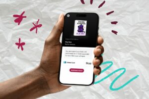 A hand holds a phone that has the new 'suspend hold' Libby feature pulled up on the screen